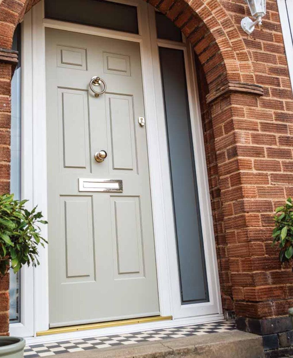 Comp Door cottage style door in Cream with classic arched brick surround