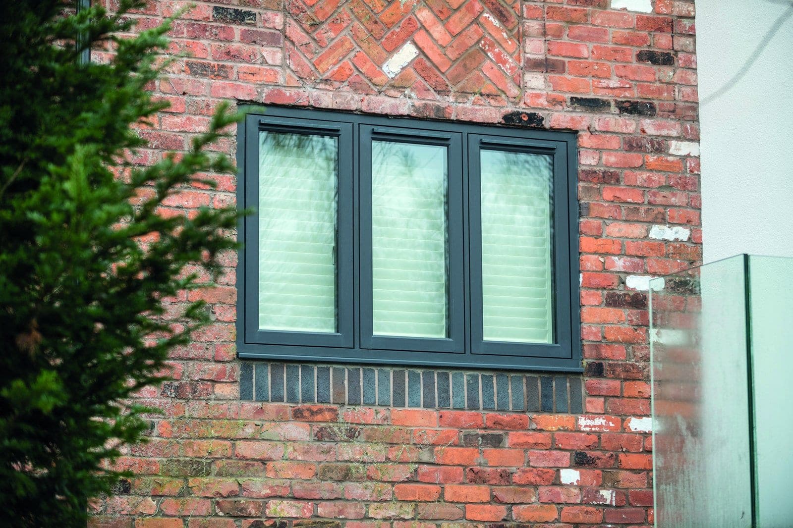 Residence² flush-sash uPVC windows in a deep contemporary grey finish on a period red brick property