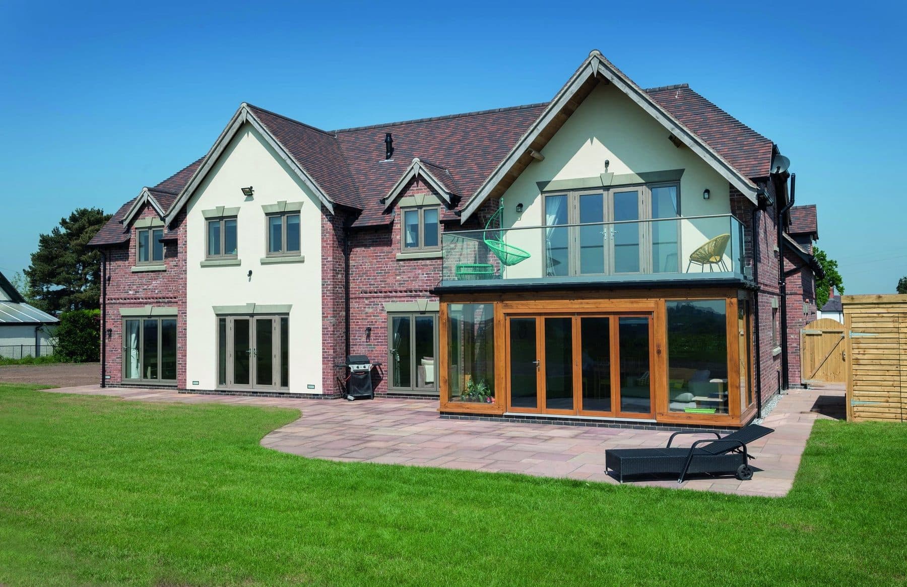 A premium country home featuring The Residence Collection R² flush-sash uPVC windows across the rear elevation