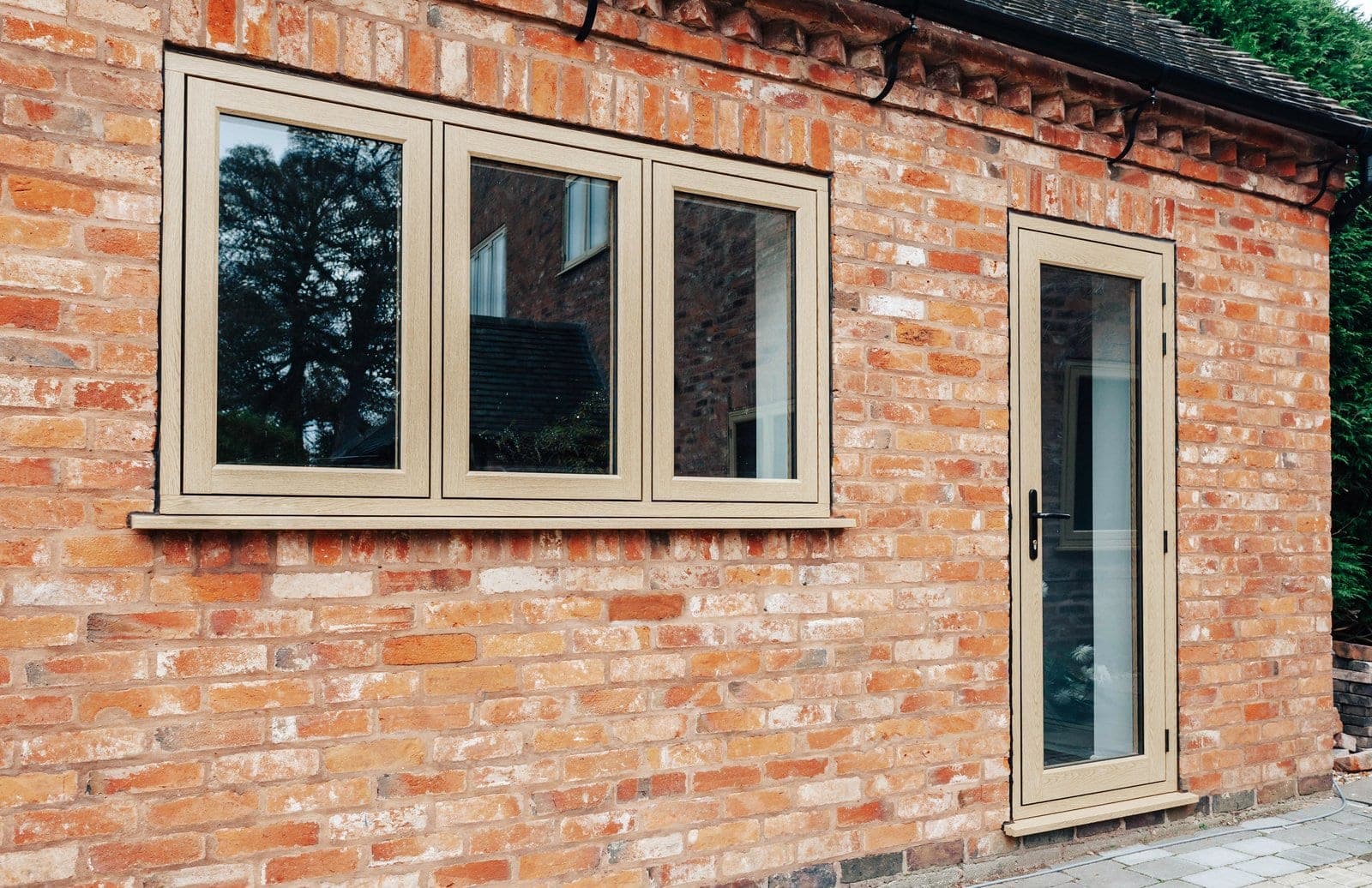 Residence 9 flush-sash uPVC windows in English Oak on a period red brick property