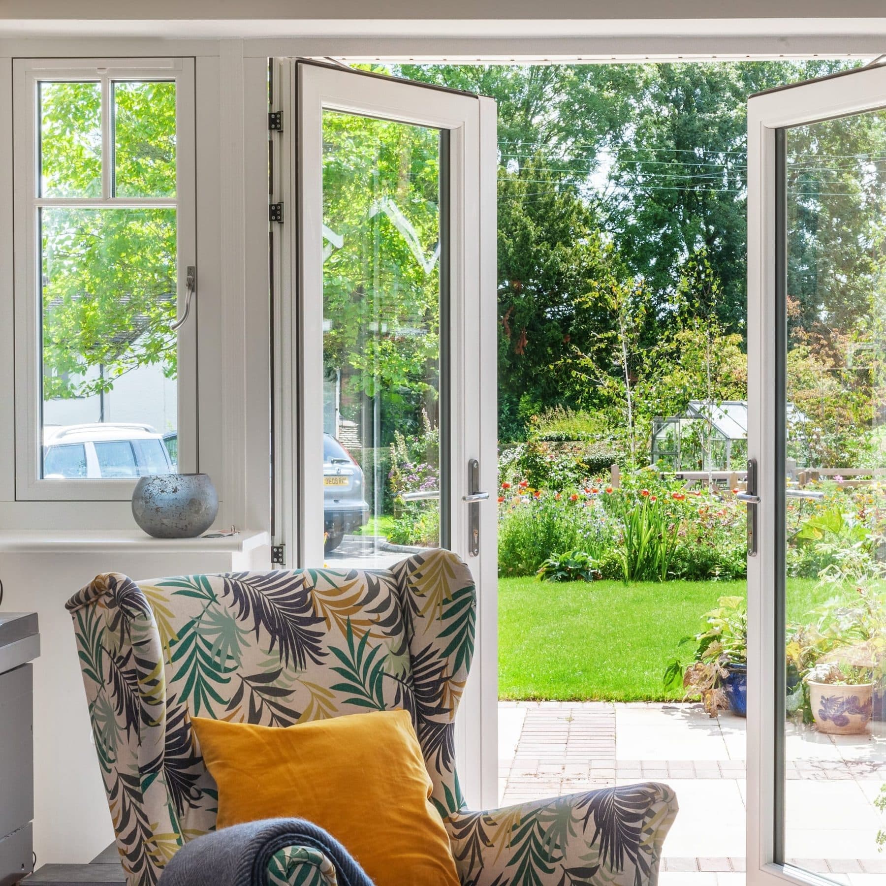 White Origin French doors opening onto a country garden