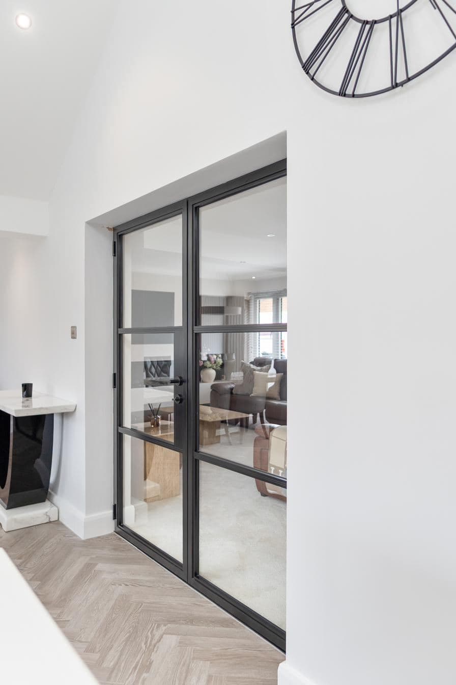 A Custom Choice internal Crittall-style glazed door install separating a hallway from a living room