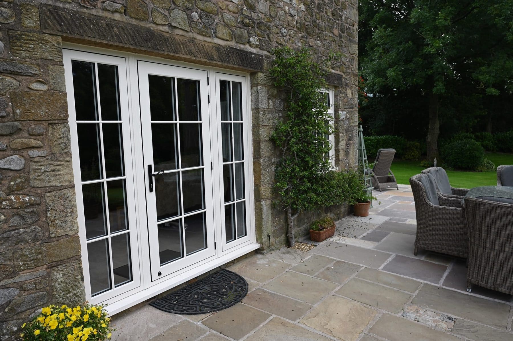 Cream composite door on a traditional stone cottage