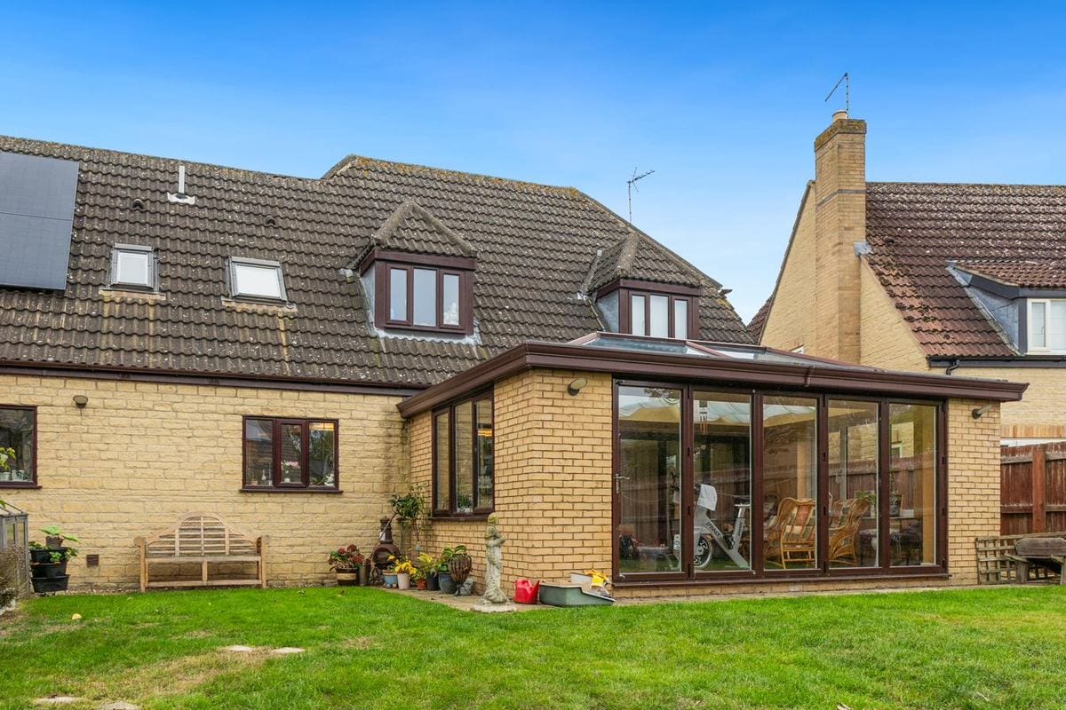 Traditional conservatory with glass roof lantern on a stone bungalow rear elevation