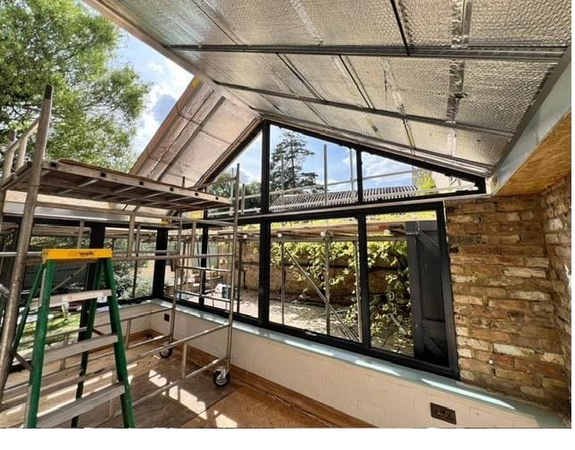 Conservatory under construction showing structural framework and roof glazing