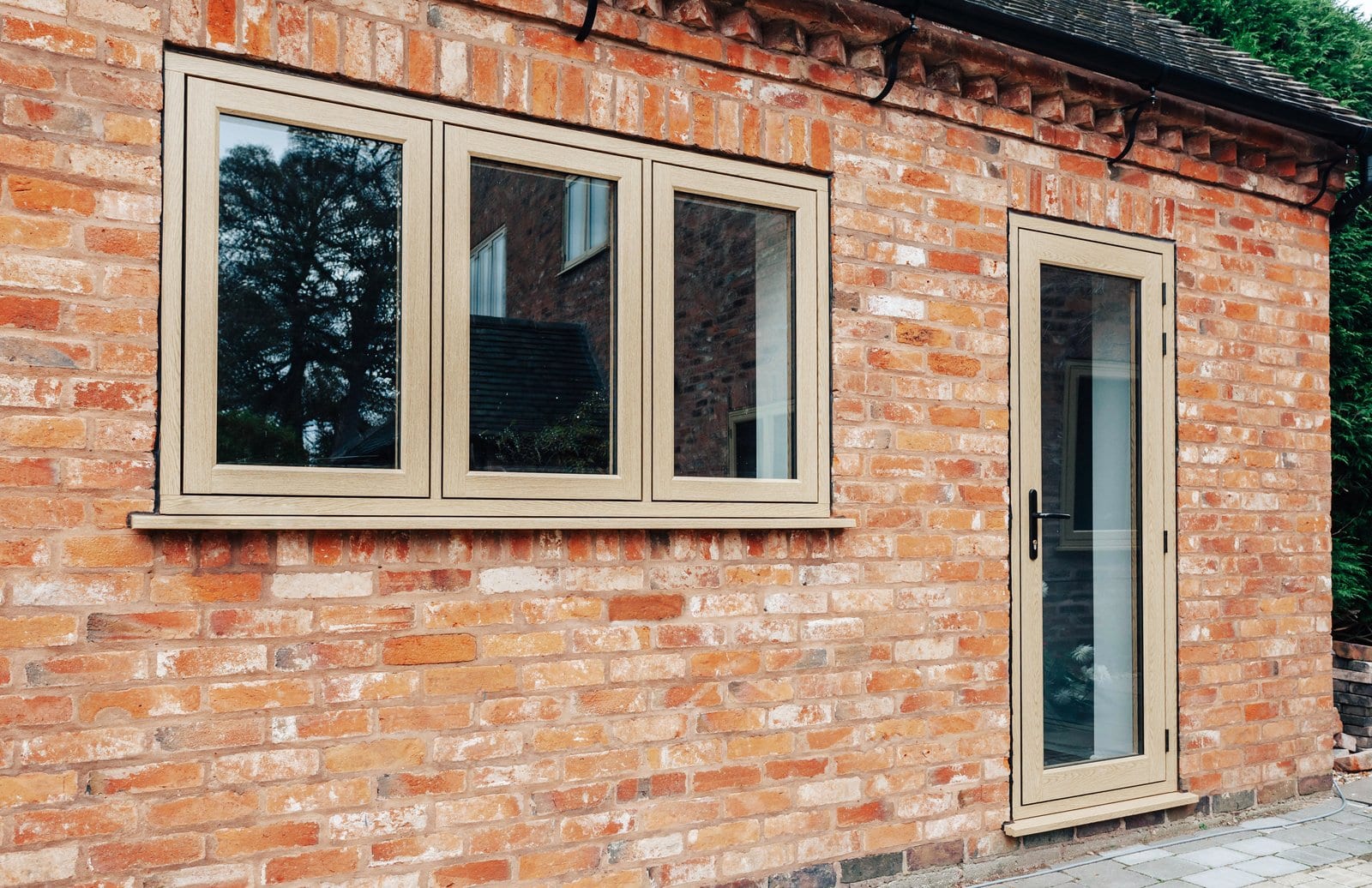 Residence Collection R9 flush-sash uPVC windows in English Oak on a period red brick property