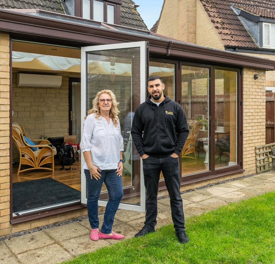 Tariq Quaddus of Custom Choice with a Peterborough customer at the handover of her new conservatory