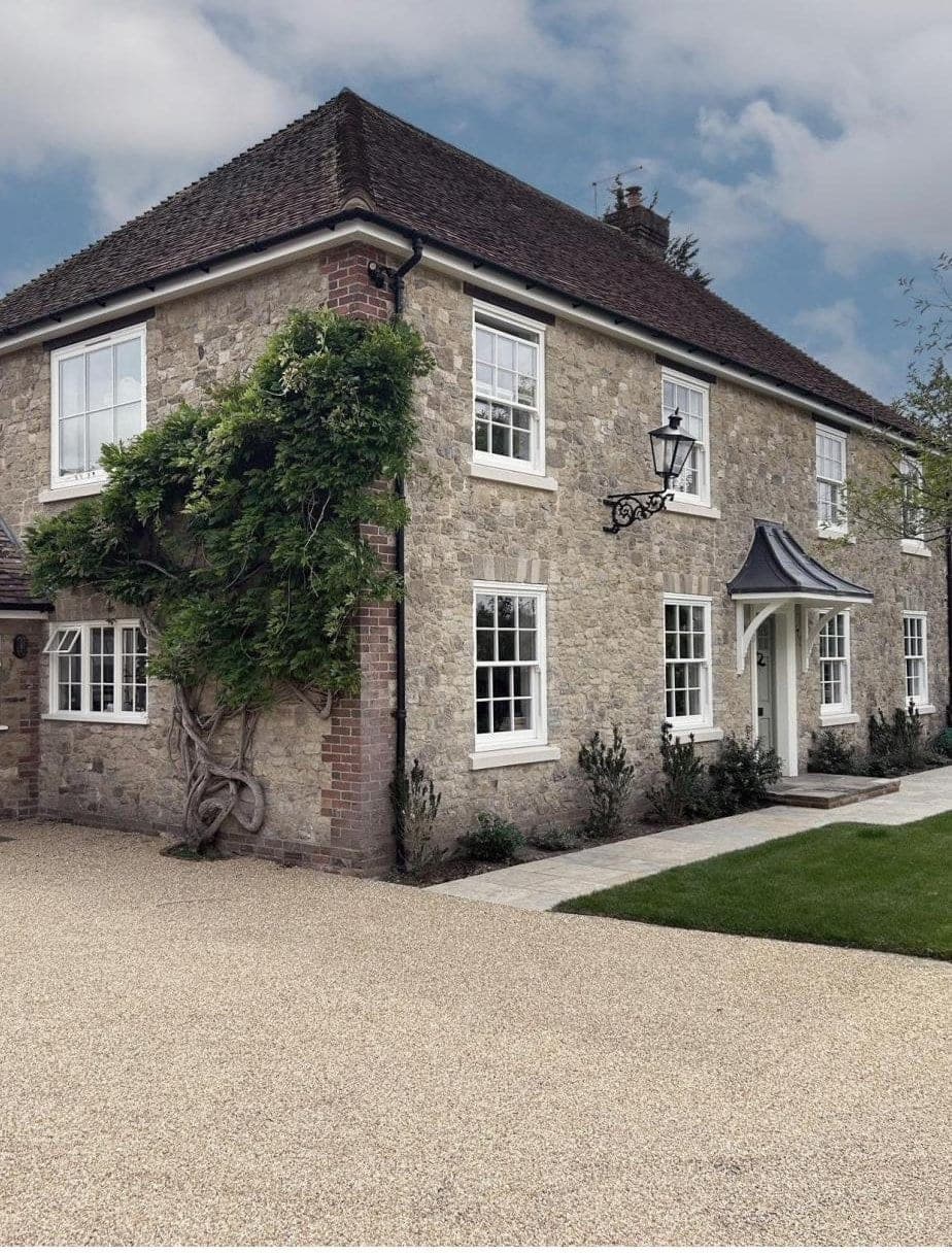 Rose Collection timber-alternative sash windows on a Cotswold stone cottage